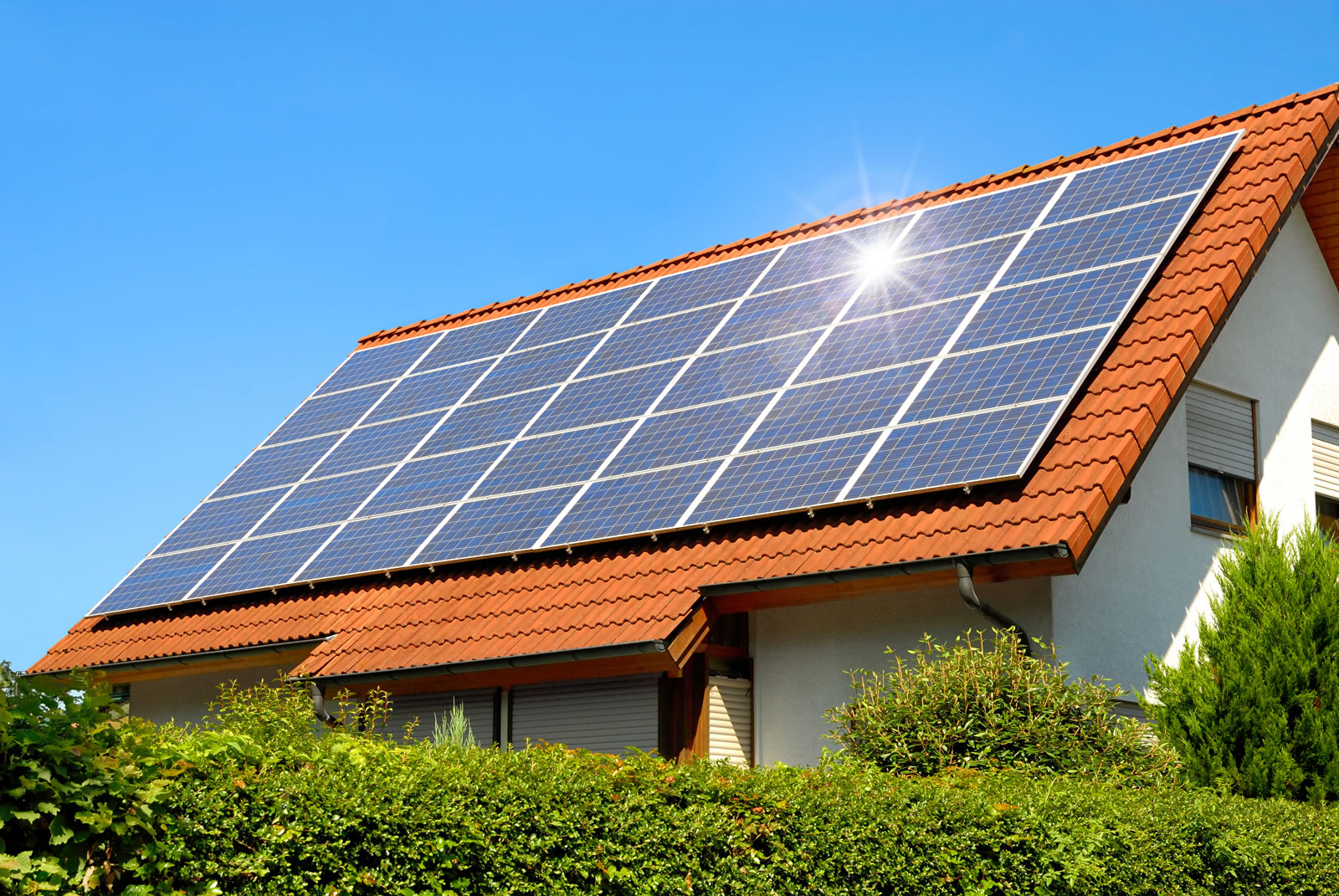 Solar panels on the roof of detached house generating renewable energy